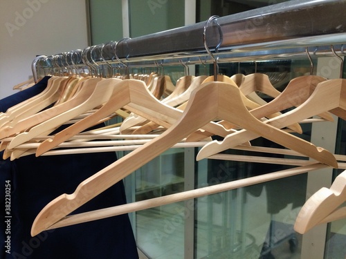Wooden hangers on a metal rack in a hotel wardrobe, checkroom in Brussels