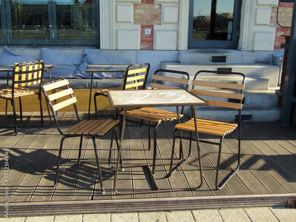 Cafe terrace with table and chairs on the sunny Danube bank in February in Budapest, Hungary