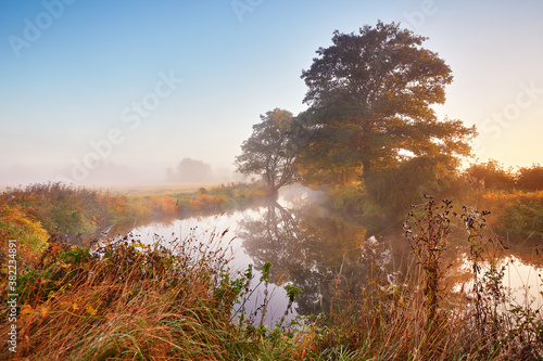 Obraz na płótnie Autumn sunrise rural landscape. Fog on river. October fall calm morning misty scene w salonie