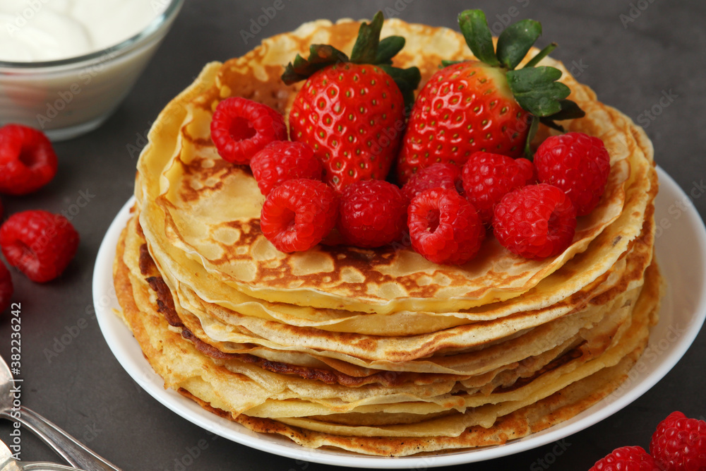 Russian cuisine national dish bliny with fresh berries Russian cuisine national dish bliny with fresh berries