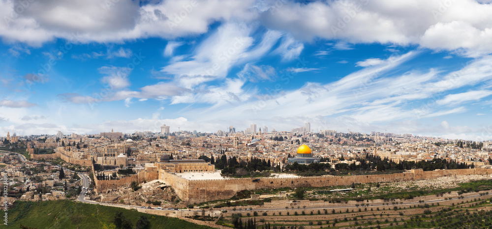 Beautiful panoramic aerial view of the Old City, Tomb of the Prophets and Dome of the Rock. Blue Sunny and Cloudy Sky Overlay. Jerusalem, Capital of Israel. Historic Architecture
