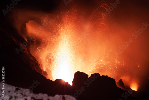 Live volcano eruption at Stromboli volcano in Italy. We contemplate the ash, lava and magma exploding over and around the rocks of the landscape