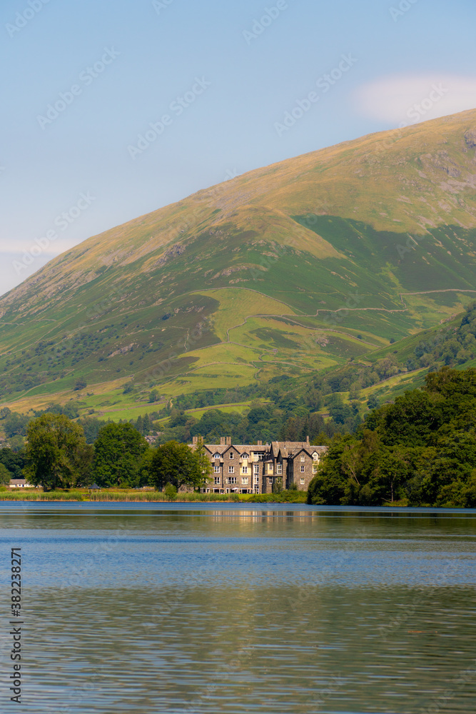 Sunny day over Lake Grasmere, amazing scene with part of Fairfield Peak on the back.