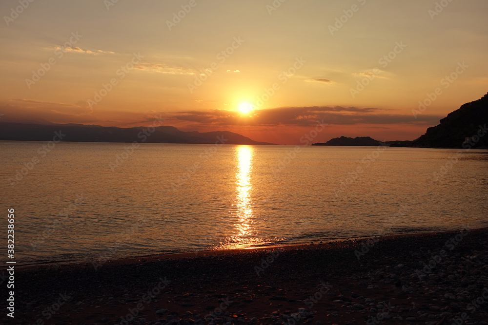 Beautiful sunset over Aegean sea as seen from Santorini island, Cyclades, Greece