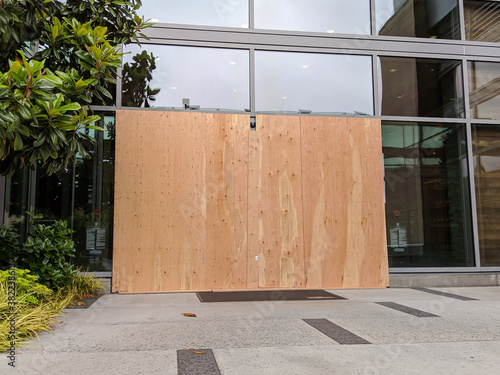boarded up windows and doors in a downtown building during protests and riots
