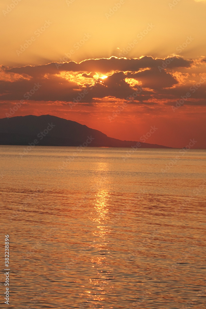 Beautiful sunset over Aegean sea as seen from Santorini island, Cyclades, Greece Beautiful sunset over Aegean sea as seen from Santorini island, Cyclades, Greece