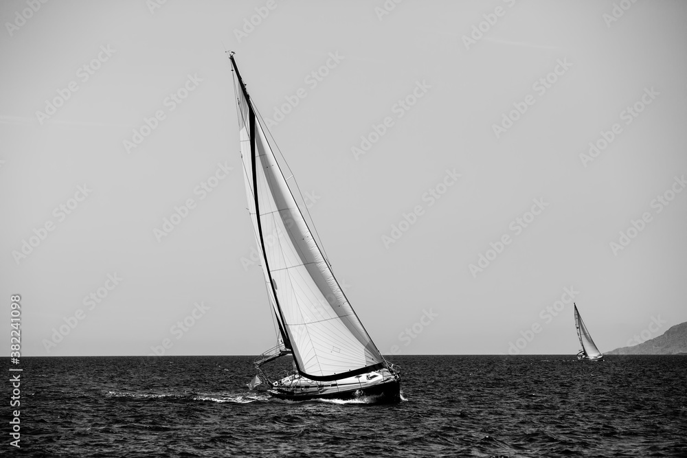 Luxury sailing. Sailboat in the regatta in the Aegean Sea. Black and white photography.