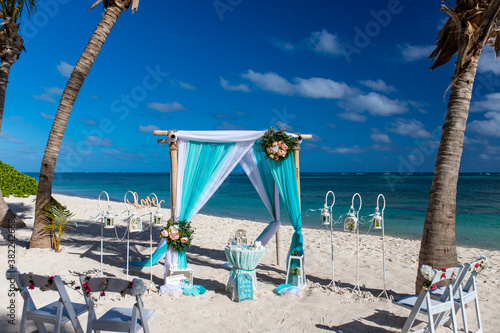 Obraz na plátně Wedding bamboo gazebo, decorated with tropical flowers and coloured fabrics on t