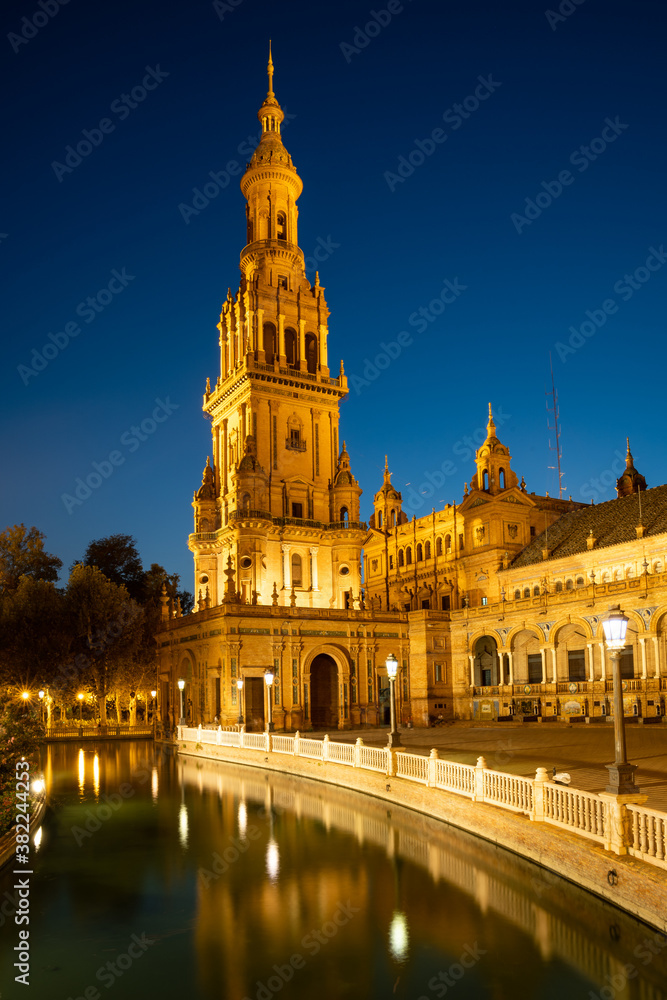 The North Tower of Plaza de Espana lit up at night, Parque de Maria Luisa, Seville, Andalusia, Spain The North Tower of Plaza de Espana lit up at night, Parque de Maria Luisa, Seville, Andalusia, Spain