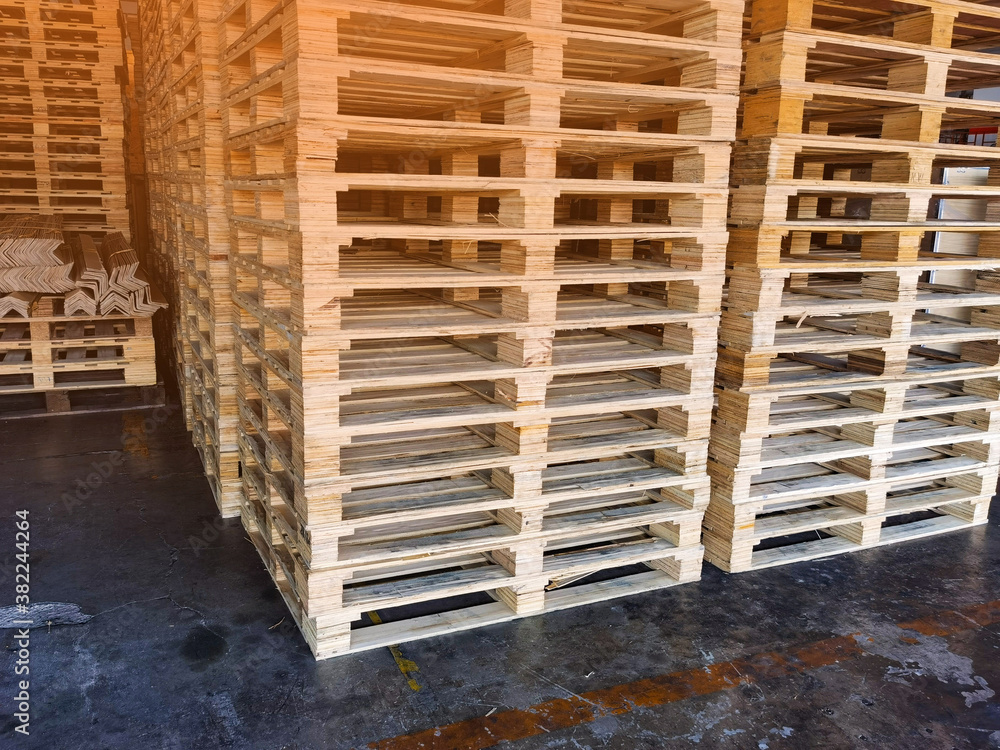 Worker driving forklift to loading wooden pallets from truck to warehouse cargo storage, shipment in logistics and transportation industrial, wood pallets stack, delivery service Worker driving forklift to loading wooden pallets from truck to warehouse cargo storage, shipment in logistics and transportation industrial, wood pallets stack, delivery service