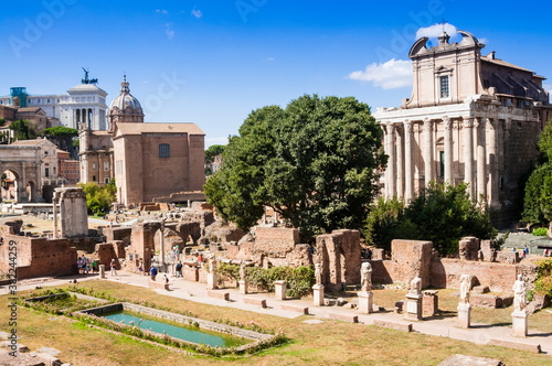 Statues at House of the Vestal Virgins, Temple of Antoninus and Faustina behind, Roman Forum, Rome, Lazio photo