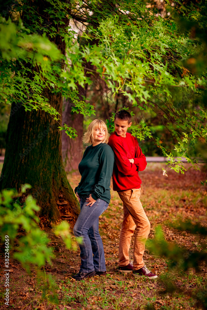 Beautiful woman,blonde,middle-aged,with a big son walking in the Park,a beautiful autumn day Beautiful woman,blonde,middle-aged,with a big son walking in the Park,a beautiful autumn day