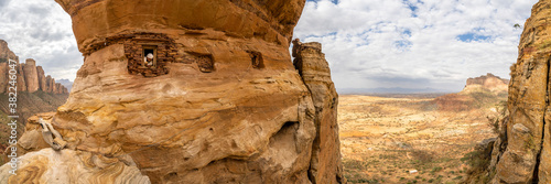 Aerial panoramic by drone of priest looking out from Abuna Yemata Guh rock-hewn church, Gheralta Mountains, Tigray region, Ethiopia photo