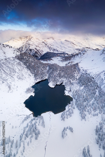 Lake Cavloc surrounded by snow, aerial view, Bregaglia Valley, Engadine, canton of Graubunden, Switzerland photo