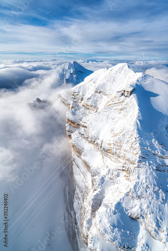 Aerial view of snow capped Tofane group and scenic Freccia nel Cielo cableway, Dolomites, Belluno province, Veneto photo