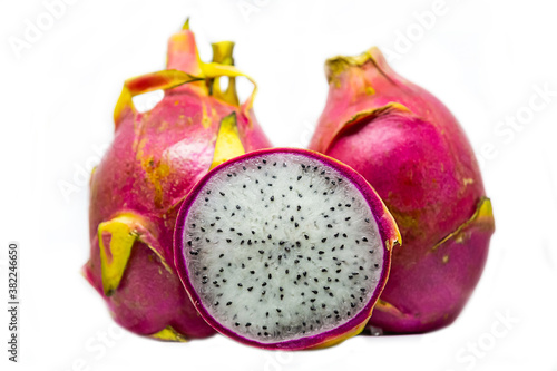 dragon fruit a pair of whole and half with white flesh and black seeds on an isolated background