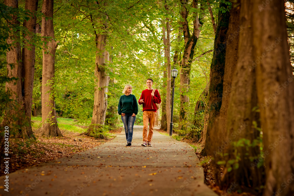 Beautiful woman,blonde,middle-aged,with a big son walking in the Park,a beautiful autumn day Beautiful woman,blonde,middle-aged,with a big son walking in the Park,a beautiful autumn day