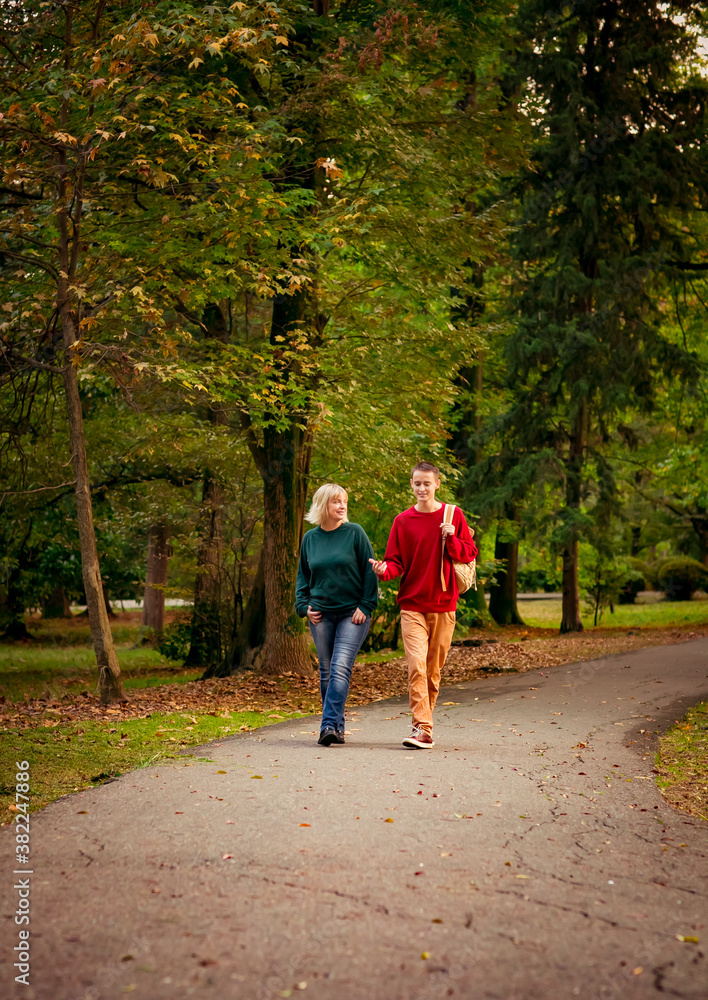 Beautiful woman,blonde,middle-aged,with a big son walking in the Park,a beautiful autumn day Beautiful woman,blonde,middle-aged,with a big son walking in the Park,a beautiful autumn day