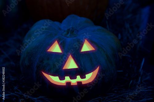 halloween decor smiling pumpkin with a grin burning out of the dark © Kai Beercrafter