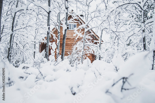 A cozy log cabin in the snowy winter landscape