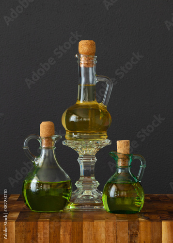 Wallpaper Mural flask flagon glass with different oils on rustic table Torontodigital.ca