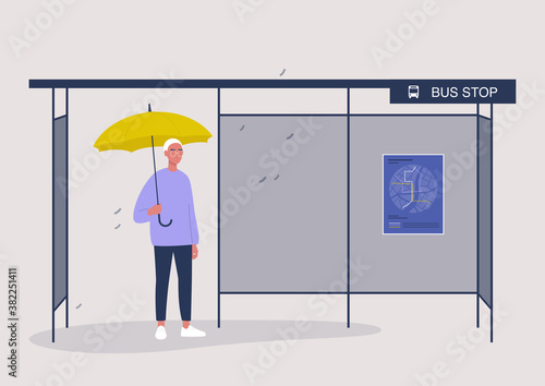 Rainy autumn weather, a male character waiting for a bus under the yellow umbrella