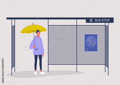 Rainy autumn weather, a female character waiting a bus under the yellow umbrella