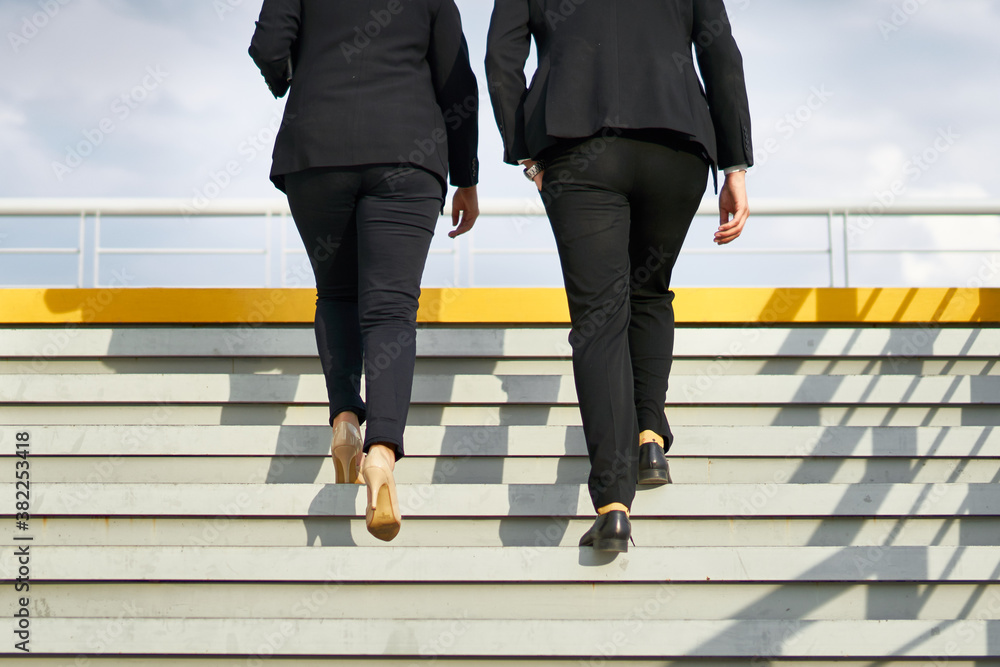 Anonymous photo of businesspersons walking up stairs