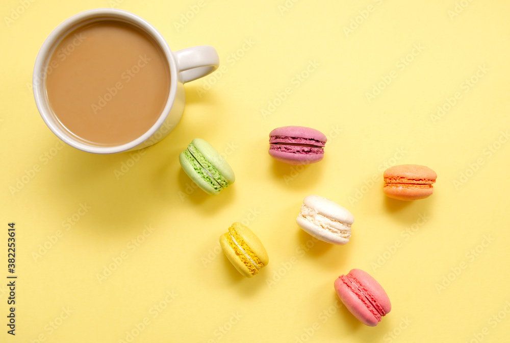 Set of colorful macaroons and coffee. Pastries, pastries and a cup of coffee with milk on a yellow background. Confectionery. good morning. Copy space. view from above.