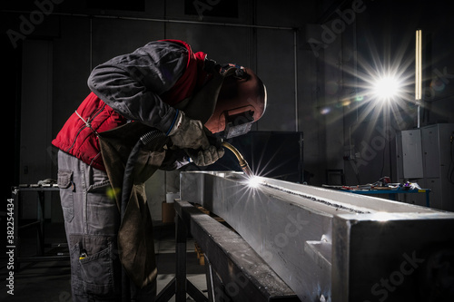 Welder that welds aluminum in his workshop photo