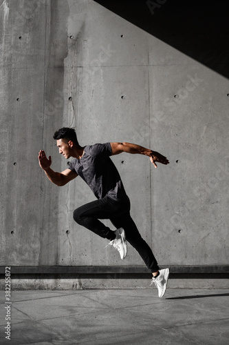 Runner practices his running skills outside with fast pace and goes for run