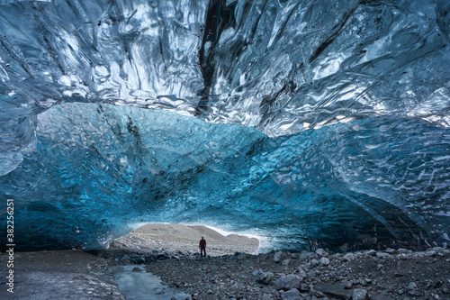Man standing inside an Ice Cave in Breiðármerkurjökull outlet glacier, Vatnajökull National Park, Southeast Iceland.