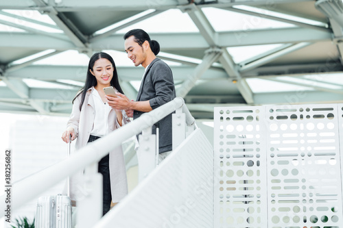 Business people using cell phone in airport photo