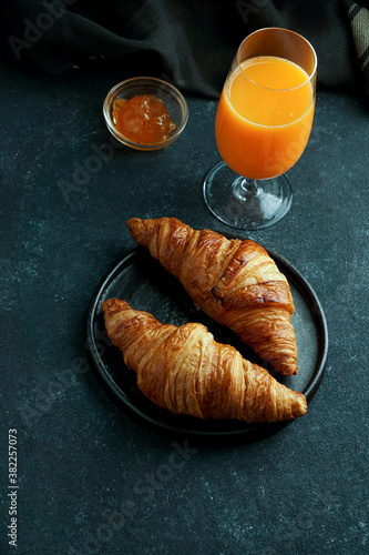croissants with fresh orange juice and jam, tipical cotinental breakfast