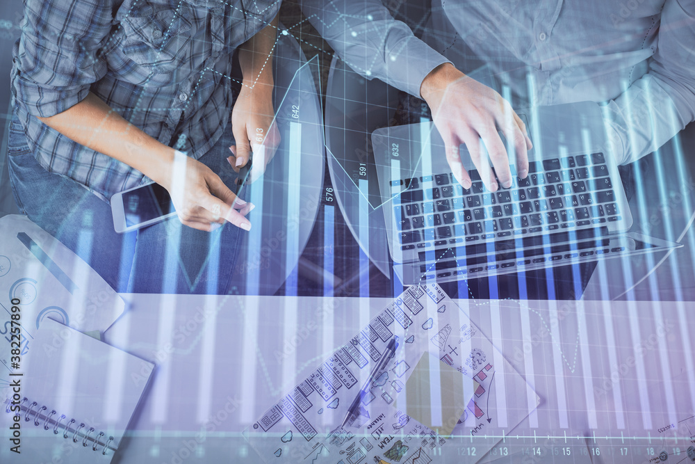 Multi exposure of man and woman working together and forex graph hologram drawing. Financial analysis concept. Computer background. Top View. Multi exposure of man and woman working together and forex graph hologram drawing. Financial analysis concept. Computer background. Top View.