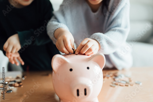 Family saving money in a piggybank