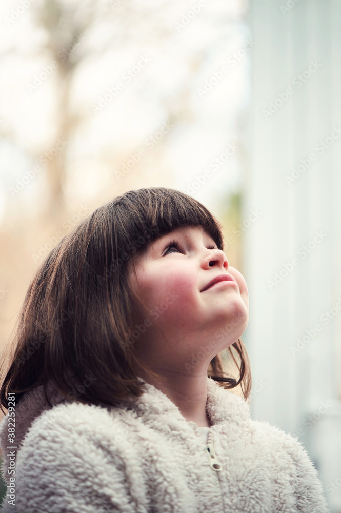 Little girl looking up and smiling Little girl looking up and smiling