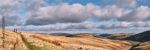 Father and son walking in the Cheviot Hills. Northumberland, UK.