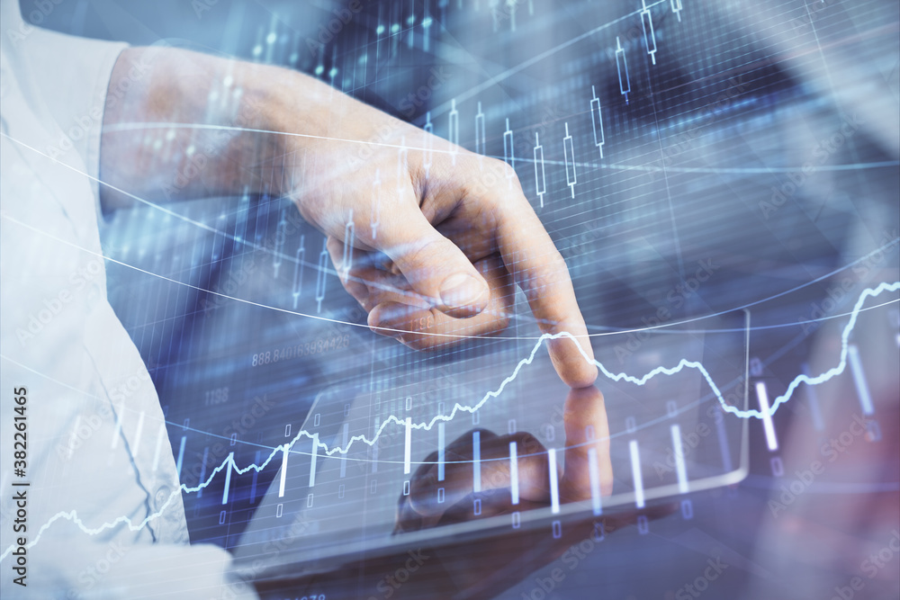 Double exposure of man's hands holding and using a digital device and forex graph drawing. Financial market concept. Double exposure of man's hands holding and using a digital device and forex graph drawing. Financial market concept.