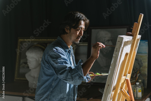 Male artist woking in studio photo