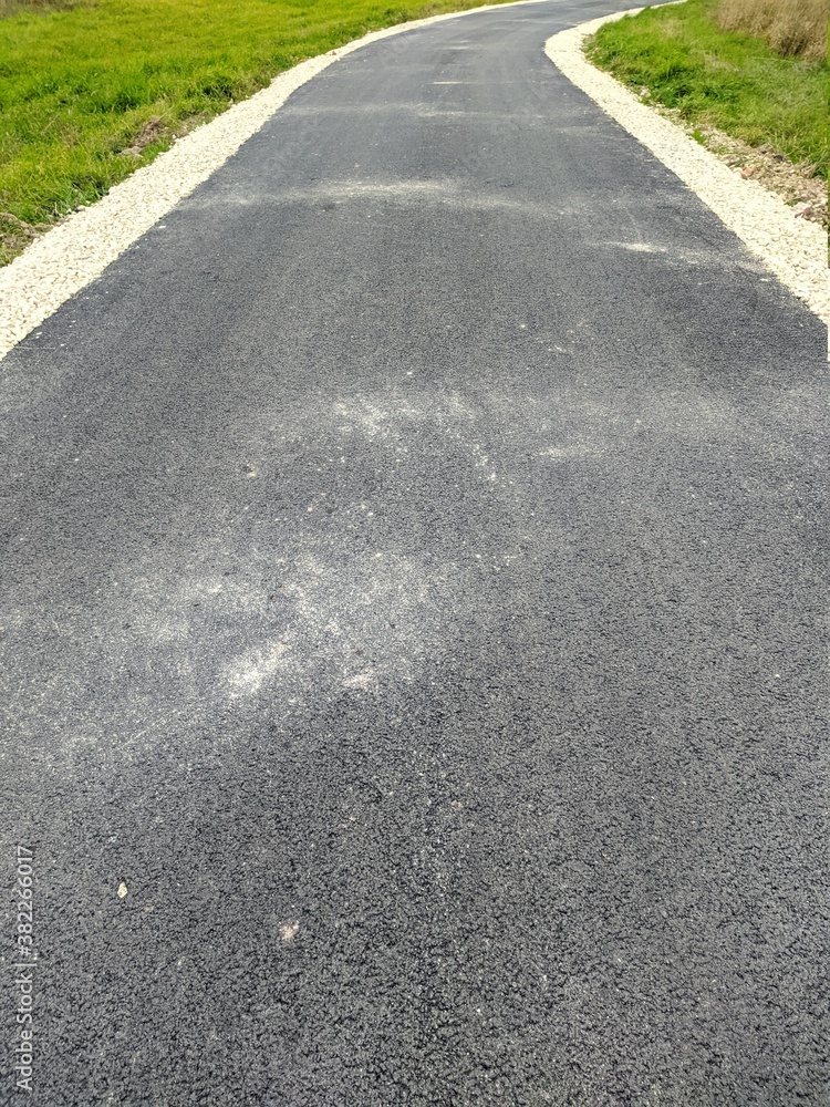 Obraz premium fresh asphalt in the field in the evening