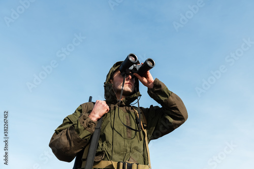 Huntsman exploring nature against blue sky photo