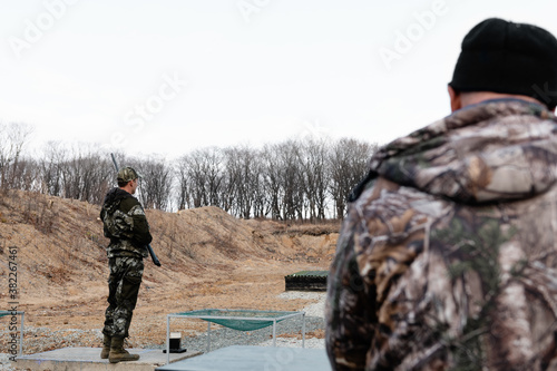 Men practicing on shooting range photo