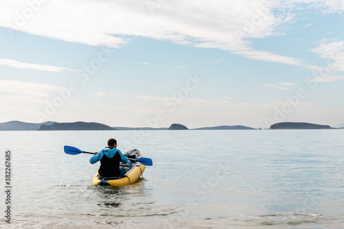 Wallpaper Mural Anonymous man sitting in kayak in sea Torontodigital.ca