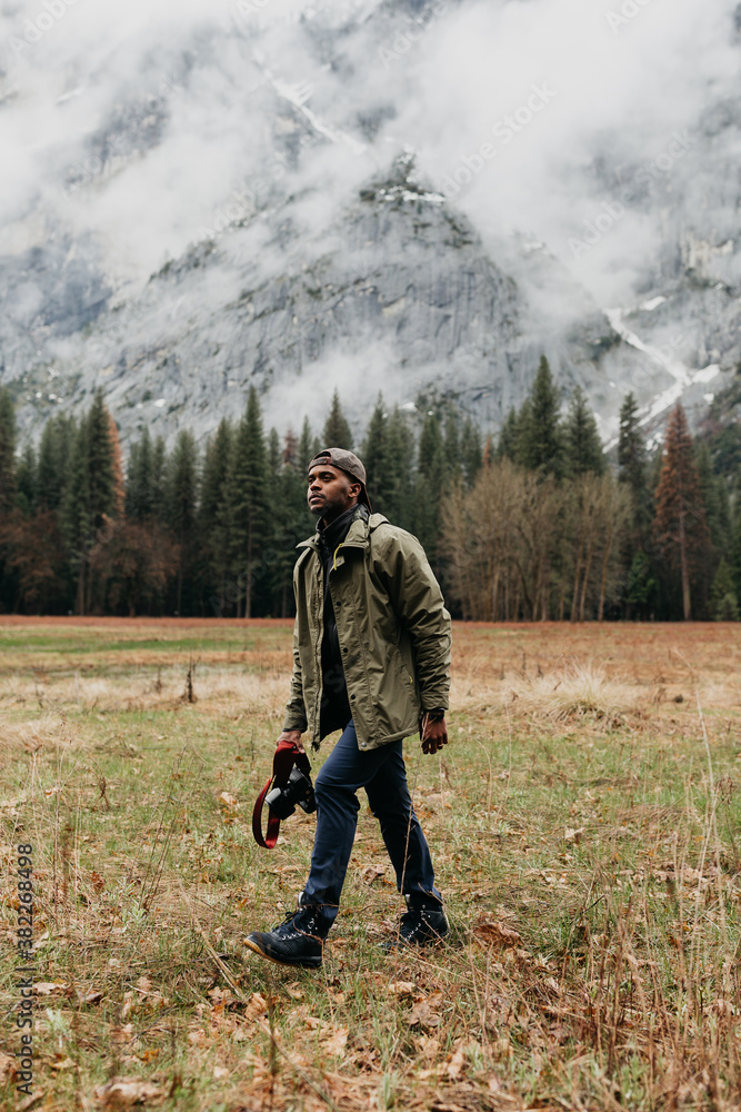 An African American man with his camera, exploring Yosemite Valley An African American man with his camera, exploring Yosemite Valley