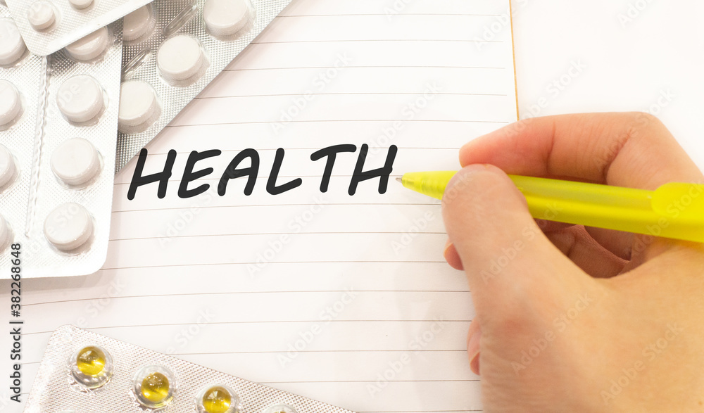 Text health on white background. There are various pills and vitamins around. Medical concept Text health on white background. There are various pills and vitamins around. Medical concept