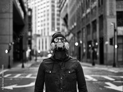 Man Wearing Respirator Mask in Empty City Looking up