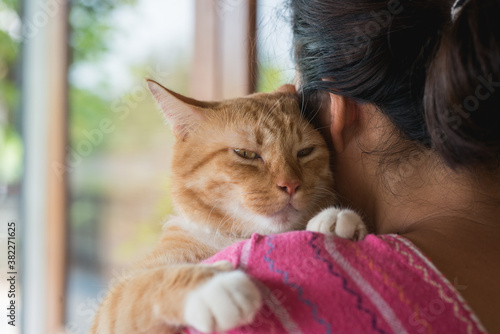 Asian woman hugging cat photo