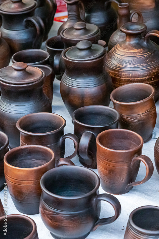 pottery pattern dark brown set mug and jug standing on counter at rural fair pottery pattern dark brown set mug and jug standing on counter at rural fair