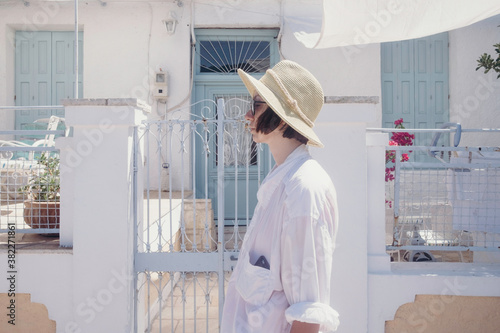 Portrait of a short hair female model with sunhat on the street at Paxos Island photo